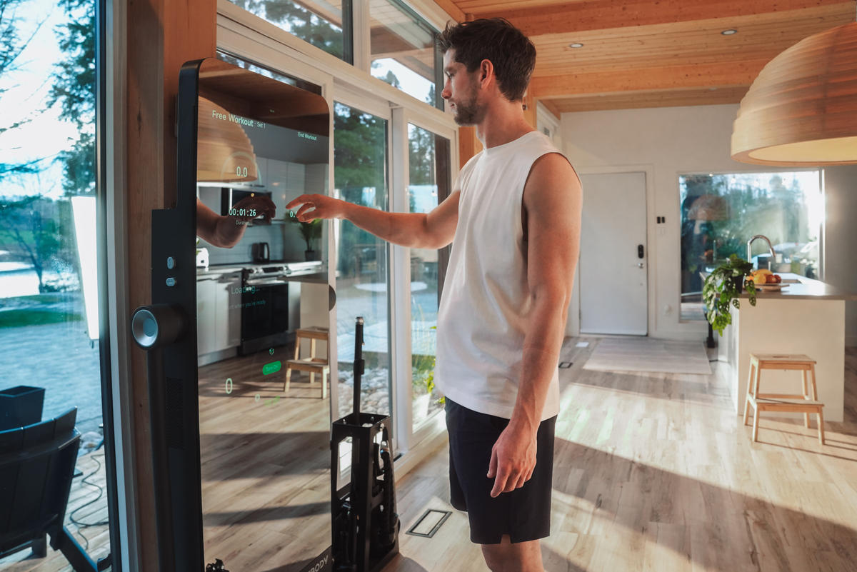 Person performing a full-body strength workout at home using IMBODY Power S digital resistance and smart arms
